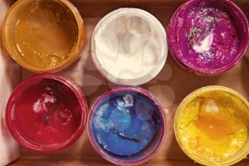Jars with art gouache paints of different colors vintage color-look