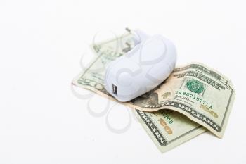 usb-charger over heap of dollar on white background. Economy of energy concept