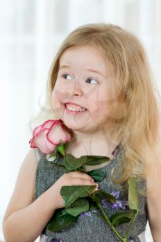 Royalty Free Photo of a Little Girl Holding a Rose