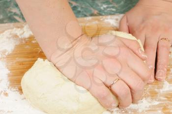 Royalty Free Photo of a Woman Kneading Dough