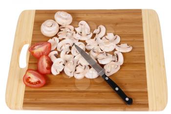mushrooms to cut on brown chopping board                                 