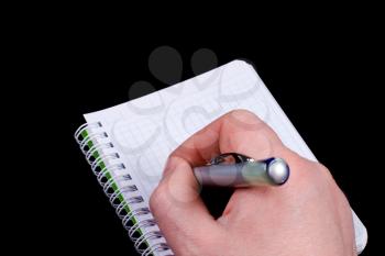 Royalty Free Photo of a Person Writing in a Notebook