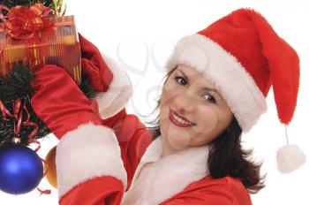 Royalty Free Photo of a Woman Dressed as Santa Decorating a Tree