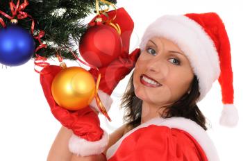 Royalty Free Photo of a Woman Dressed as Santa Decorating a Tree
