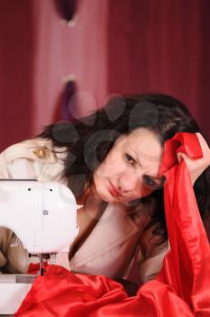 Royalty Free Photo of a Woman Using a Sewing Machine