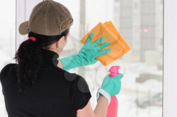 Royalty Free Photo of a Woman Washing a Window
