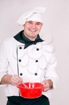 smiling chef mixes the dough in a bowl