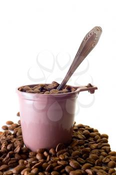 Royalty Free Photo of a Spoon  in a Cup Full of Coffee Beans