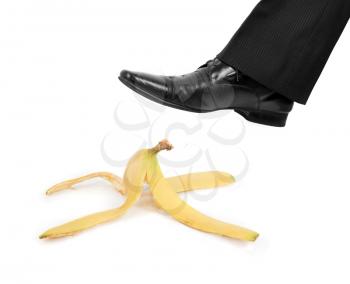 Royalty Free Photo of a Businessman Stepping on a Banana Peel