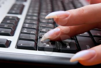Royalty Free Photo of a Woman Typing on a Keyboard