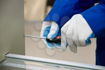 Royalty Free Photo of a Worker Holding a Screwdriver