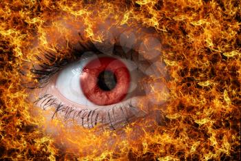 Royalty Free Photo of a Close-up of a Red Eye on Fire