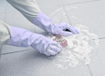 Royalty Free Photo of a Person Scrubbing the Floor