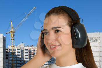 Royalty Free Photo of a Woman Wearing Safety Earphones at a a Building Site