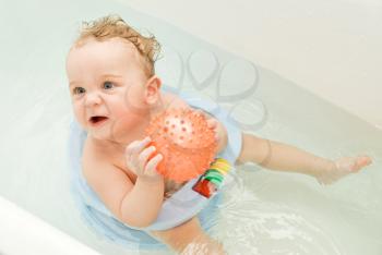 Royalty Free Photo of a Toddler Playing in the Bath