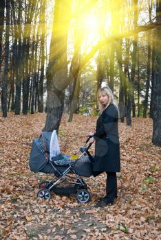 Royalty Free Photo of a Woman Pushing a Stroller 