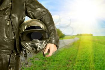 Royalty Free Photo of a Biker Holding a Helmet
