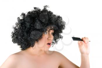Royalty Free Photo of a Woman Combing Her Wig