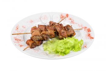 Kebab from chicken liver wrapped with bacon and garlic sauce
