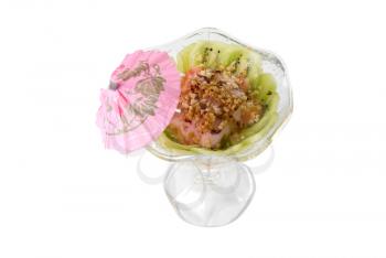 Tasty dessert with kiwi and nuts on white
