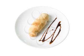 sweet bun with chocolate at plate isolated on a white