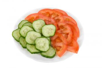Fresh vegetables: cucumbers and tomatoes on plate