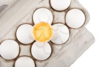 Royalty Free Photo of a Carton of Eggs With a Broken One