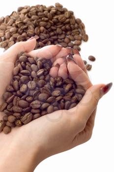 Royalty Free Photo of a Hand Holding Coffee Beans
