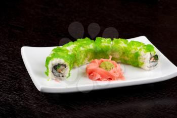 Sushi rolls made of salmon, avocado, flying fish roe - tobiko caviar and philadelphia cheese
