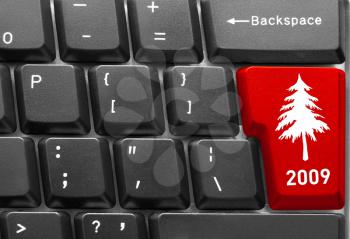 Close-up of computer keyboard with red Christmas tree key