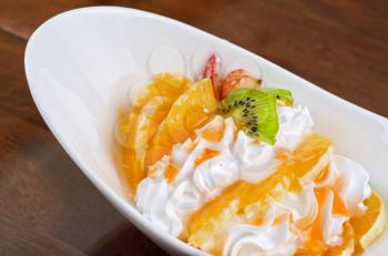Ice cream dessert with kiwi, strawberry and orange