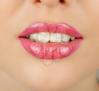 Close up of a young woman's glossy lips