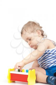 Small baby boy with a toy isolated on white