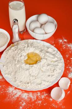 Baking ingredients: eggs, flour, sugar, salt and milk