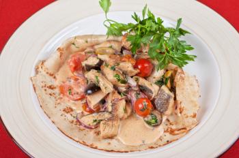 pancake with peled fish, different vegetables and sauce
