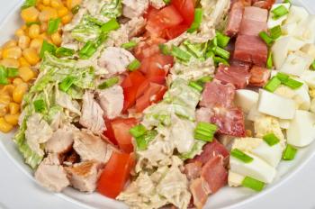 Salad with bacon, chicken, tomato, eggs and corn