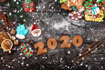 Different ginger cookies for new 2020year holiday on wooden background, xmas theme