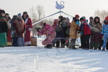 SVETLOE LAKE. ALTAISKIY KRAI. WESTERN SIBERIA. RUSSIA - DECEMBER 2, 2018: Folk national winter games (knock down the bottle from felt boots ) in the Altaiskaya Zimovka holiday - the first day of winter on December 2, 2018 in Altayskiy krai, Siberia, Russia.