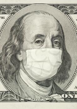 Portrait of Franklin on 100 dollar banknote with medical mask. The concept of coronavrius epidemic and the financial crisis caused by this collapse