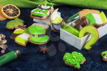 Gingerbreads cookies for Patrick's day on dark stone background