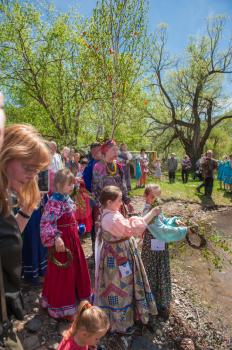 TOPOLNOE, ALTAY, RUSSIA - May 27, 2018: Folk festivities dedicated to the feast of the Holy Trinity. Ancient Russian rite: sinking a birch.