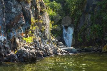 Kishte Waterfall at Lake Teletskoye in autumn Altai Mountains. The most famous lake waterfall