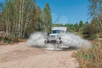 the truck passes through a puddle