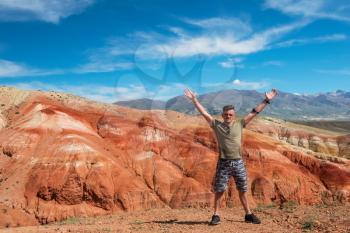 Happy man in Valley of Mars landscapes in the Altai Mountains, Kyzyl Chin, Siberia, Russia