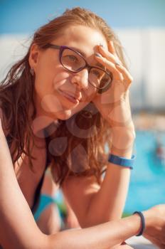 Woman closeup portrait relaxing by pool In beauty summer day