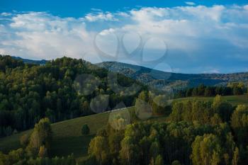 A herd of sheep in the Altai mountains. Beautiful mountain summer landscape view: green meadows, blue sky, purity air.