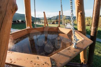 Big vat with hot water and herbs for bathing, spa and relax. Outdoor in Altai mountains, Siberia, Russia