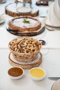 Traditional russian baked goods: pies and pretzels, samovar, honey, jam on the served table