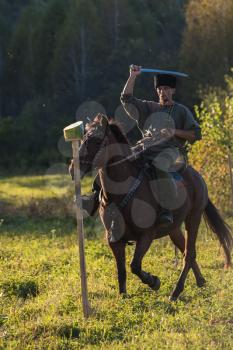 CHARISHSKOE. ALTAISKIY KRAI. WESTERN SIBERIA. RUSSIA - SEPTEMBER 15, 2016: descendants of the Cossacks in the Altai, cossack rides a horse, with a saber at the festival on September 15, 2016 in Altayskiy krai, Siberia, Russia.