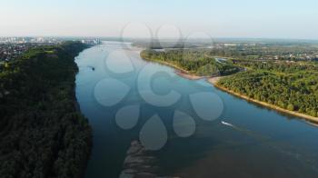 Aerial view of big siberian Ob river and boats in beauty summer day, View to Barnaul city. 4K drone footage.